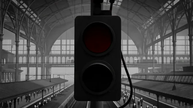 Sinal ferroviário vermelho sob a estrutura metálica de uma estação.